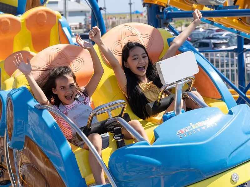 A Customer Sit in an Amusement Park Ride in Which Thrills and Safety Meet